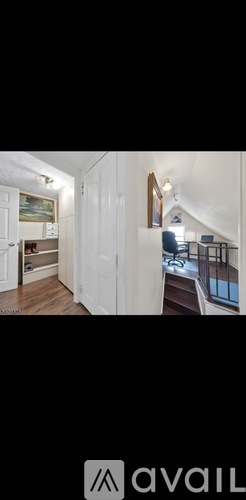 A modern interior space with white cabinetry and a painting on the wall.