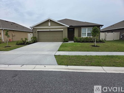 A house with a garage and a driveway in front.