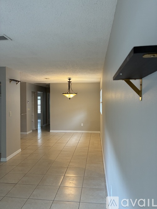 A hallway with a light fixture and a wall-mounted speaker.