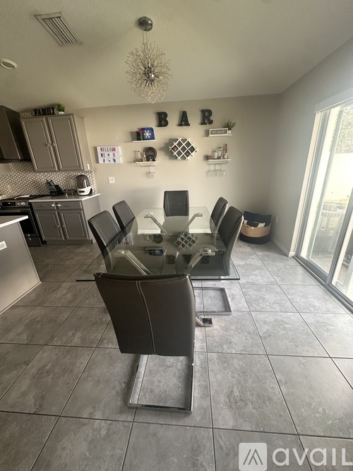 A kitchen with a dining table and chairs.