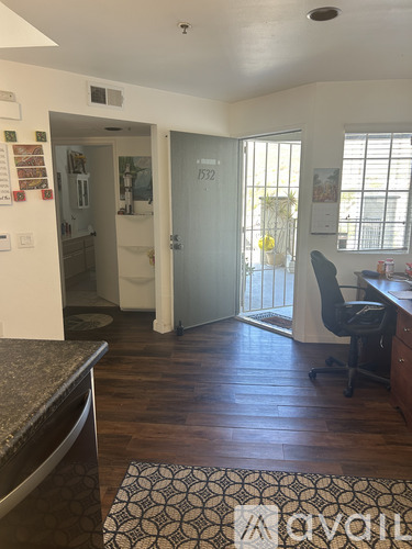 A room with a desk and a chair in it.