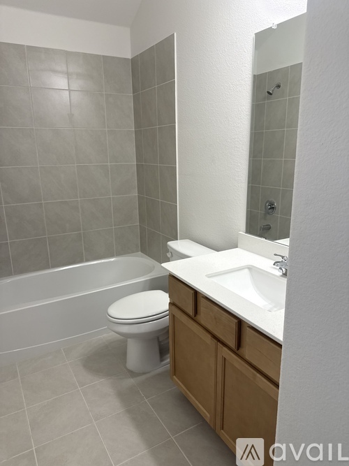 A bathroom with a white toilet and a white sink.