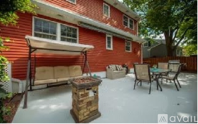 A red house with a patio and a fire pit.