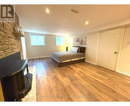 A bedroom with a bed, dresser, and television.