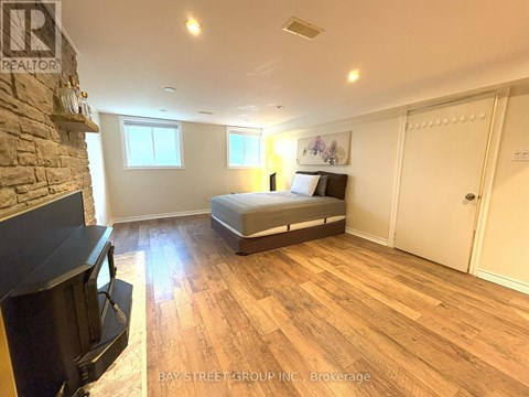A bedroom with a bed, dresser, and television.