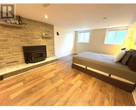 A bedroom with a fireplace and a bed.