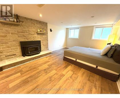 A bedroom with a fireplace and a bed.