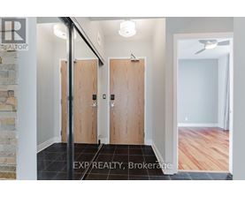 A hallway with wooden doors and a stone wall.