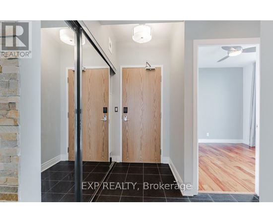 A hallway with wooden doors and a stone wall.
