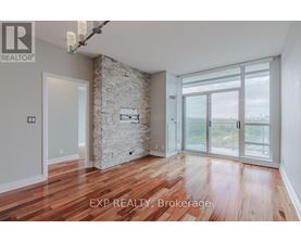A room with wooden floors and a stone wall with a glass door leading outside.