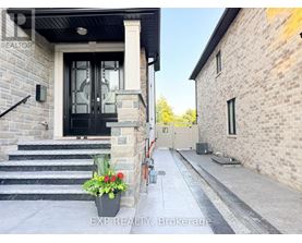 A house entrance with a black door and a sign that says REALTOR.
