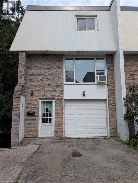 A house with a white garage door and a grey roof.