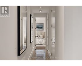 A bedroom with a bed and a painting on the wall.