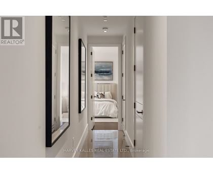 A bedroom with a bed and a painting on the wall.