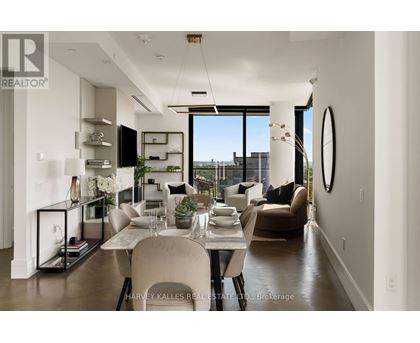 A modern dining room with a table set for two and a view of the city.
