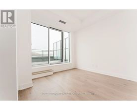 A room with a large window and a wooden floor.