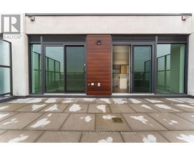 A modern building entrance with a glass door and a wooden column.