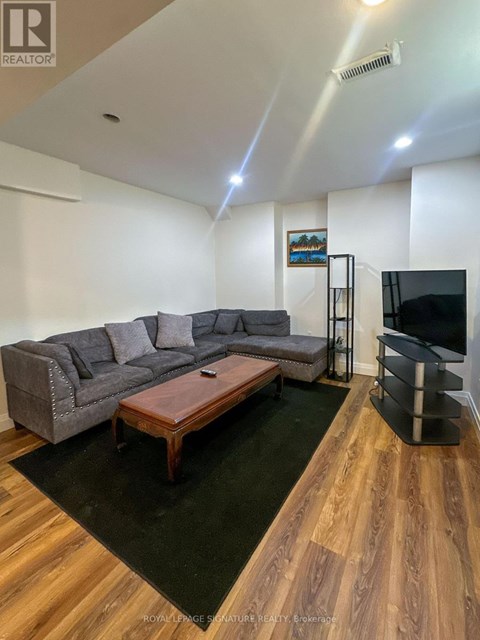 A living room with a grey couch and a wooden coffee table.