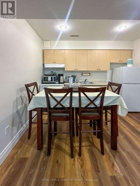 A kitchen with a table and chairs in the foreground.