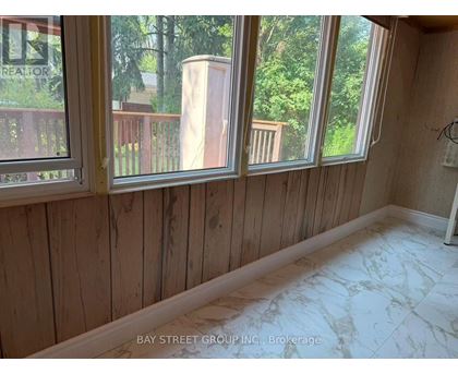 A room with wooden walls and marble flooring.