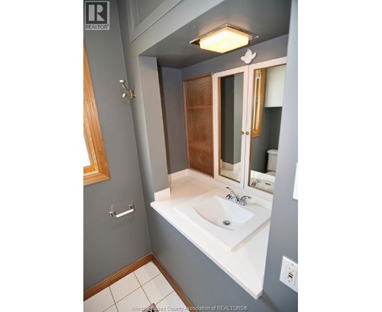 A bathroom with a sink and mirror.
