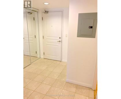 A white bathroom with a glass door shower and a white door.