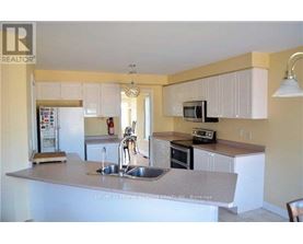A kitchen with a white counter top and a sink.