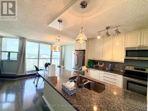 A kitchen with granite countertops and stainless steel appliances.