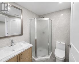 A bathroom with a sink, toilet, and shower.