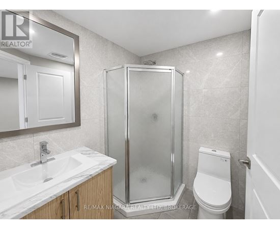 A bathroom with a sink, toilet, and shower.