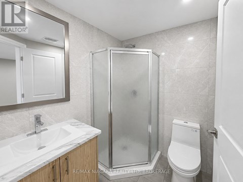 A bathroom with a sink, toilet, and shower.