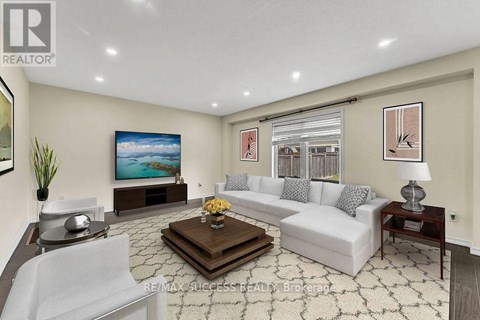 A living room with a white couch, a coffee table, and a painting on the wall.
