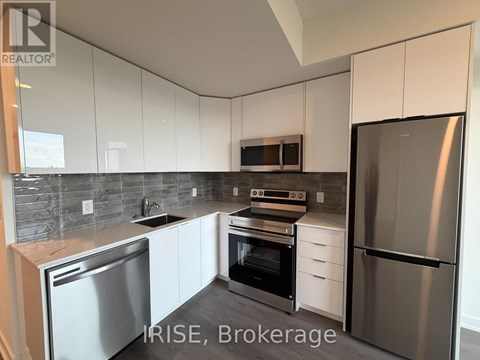 A kitchen with white cabinets and stainless steel appliances.