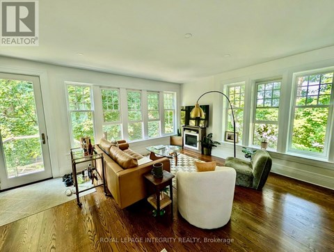 A living room with a couch, chair, and a table with a lamp on it.