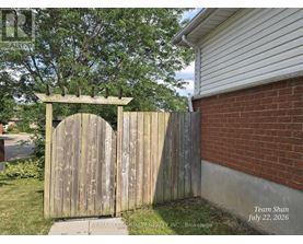 A wooden gate with a decorative arch above it.