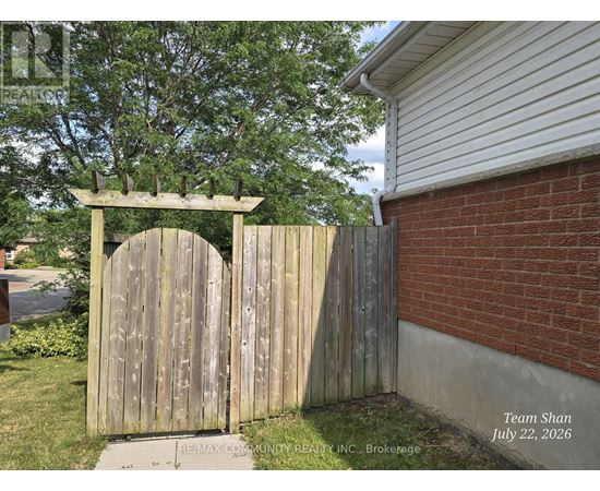 A wooden gate with a decorative arch above it.