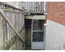 A wooden staircase leads to a door in a building.