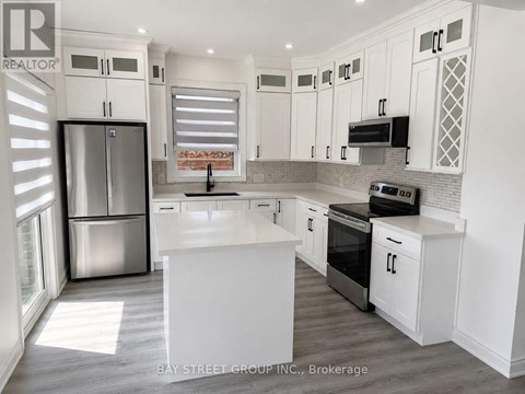 A kitchen with white cabinets and appliances.