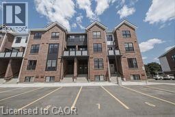 A large apartment complex with a parking lot in front.