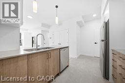 A kitchen with wooden cabinets and a refrigerator.
