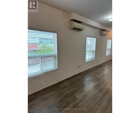 A room with a window and a wall-mounted air conditioner.