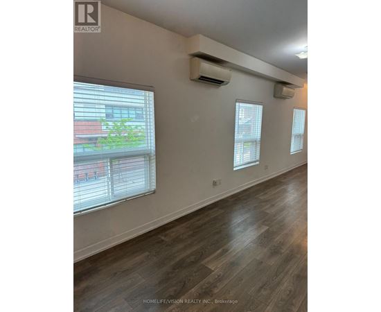 A room with a window and a wall-mounted air conditioner.