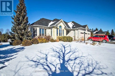 A large house with a red car parked in front.