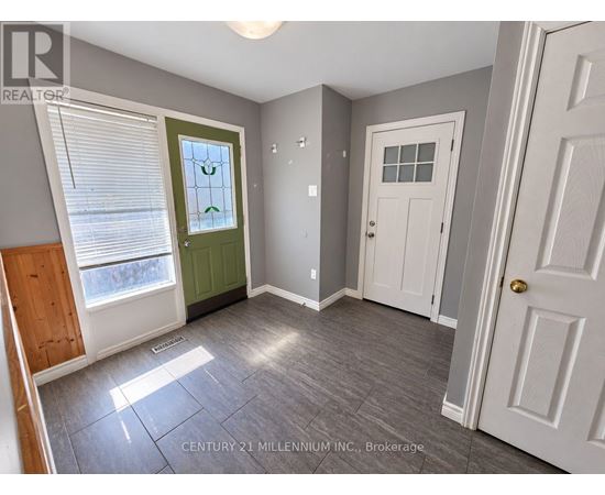 A room with a green door and a white door.