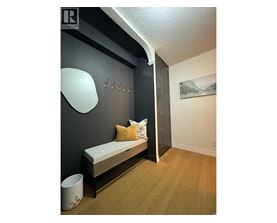 A bedroom with a bed and a painting on the wall.