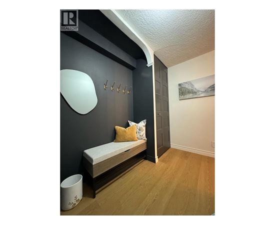 A bedroom with a bed and a painting on the wall.