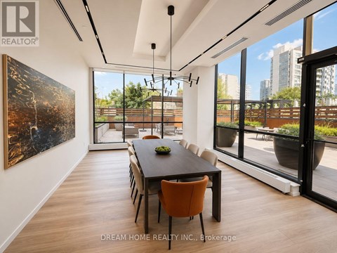 A modern dining room with a large table and chairs.
