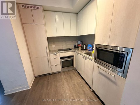 A kitchen with white cabinets and stainless steel appliances.