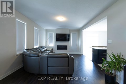 A living room with a grey sofa and a television.