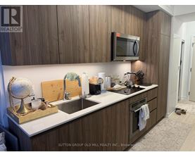 A kitchen with wooden cabinets and a white countertop.
